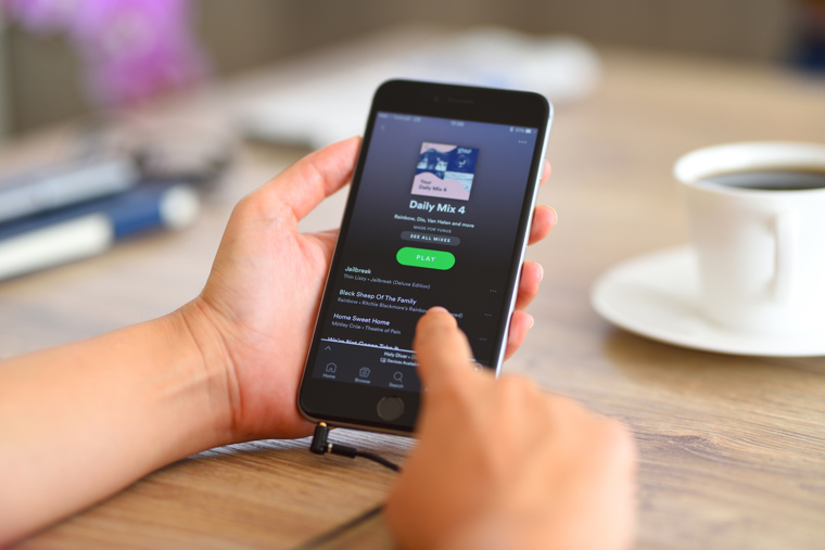 iPhone with Spotify app on the screen